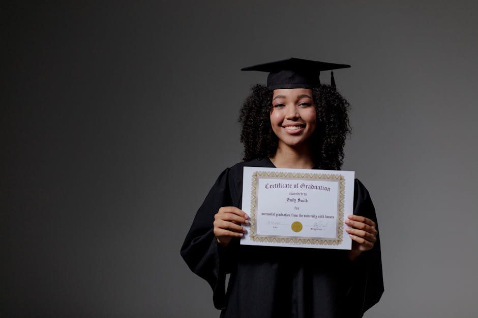 Accueil Smiling graduate proudly holding a certificate in cap and gown.